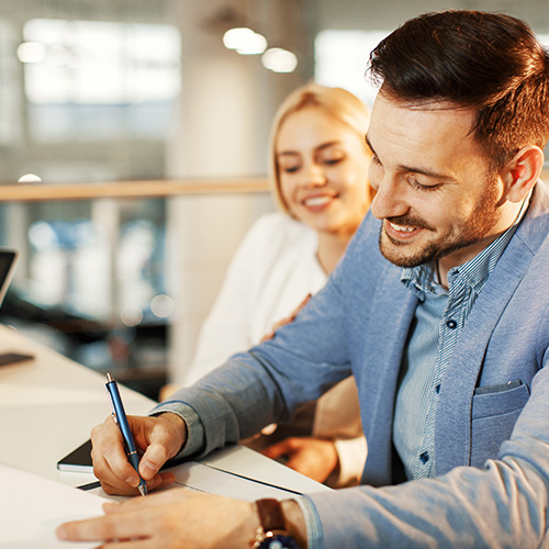 Gold Coast home - Young couple signing a contract